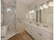 Double vanity bathroom with marble shower and updated fixtures at 784 Tartan Dr # 784, Venice, FL 34293