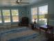 Light blue living room with multiple windows, ceiling fan, and rug at 789 N Green Cir # 146, Venice, FL 34285