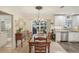 Bright dining area adjacent to the kitchen, with a view to the backyard pool at 832 Pineland Ave, Venice, FL 34285