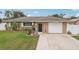 Single-story home with attached garage and landscaped yard at 832 Pineland Ave, Venice, FL 34285