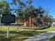 Edgewood Park with playground equipment, trees, and historical marker at 832 Pineland Ave, Venice, FL 34285