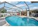 Screened pool with a seating area and grill at 832 Pineland Ave, Venice, FL 34285