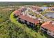 Aerial view of community with lake and various homes at 10039 Crooked Creek Dr # 203, Venice, FL 34293