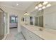 Spacious bathroom with double vanity, walk-in shower and large mirror at 10039 Crooked Creek Dr # 203, Venice, FL 34293