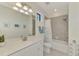 Bright bathroom featuring a shower over tub, large mirror and tiled backsplash at 10039 Crooked Creek Dr # 203, Venice, FL 34293