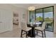 Dining area with seating for four and sliding glass doors providing a view to the exterior at 10039 Crooked Creek Dr # 203, Venice, FL 34293
