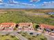 Townhome with a terra cotta colored roof, brick driveway and a large marsh view at 10039 Crooked Creek Dr # 203, Venice, FL 34293