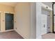Townhome exterior featuring a door with Happy Hour mat and white garage door at 10039 Crooked Creek Dr # 203, Venice, FL 34293