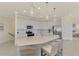 A modern kitchen boasts a large island with barstool seating and stainless steel appliances at 10039 Crooked Creek Dr # 203, Venice, FL 34293