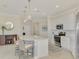 Open kitchen with island seating, white cabinets and stainless steel appliances at 10039 Crooked Creek Dr # 203, Venice, FL 34293