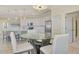 Well-equipped kitchen with white cabinets, stainless steel appliances, and eat-in counter at 10039 Crooked Creek Dr # 203, Venice, FL 34293