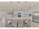 Spacious kitchen featuring white cabinets, island with seating, and stainless steel appliances at 10039 Crooked Creek Dr # 203, Venice, FL 34293