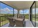 Relaxing screened lanai with outdoor furniture and nature views at 10039 Crooked Creek Dr # 203, Venice, FL 34293