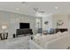 Bright living room with modern ceiling fan, neutral walls, and light grey rug at 10039 Crooked Creek Dr # 203, Venice, FL 34293
