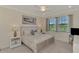 Cozy main bedroom featuring a boat painting and an inviting king-size bed at 10039 Crooked Creek Dr # 203, Venice, FL 34293