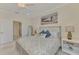 Comfortable main bedroom features a closet, a door to the bathroom and large windows at 10039 Crooked Creek Dr # 203, Venice, FL 34293