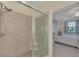 Shower with glass doors next to the main bedroom at 10039 Crooked Creek Dr # 203, Venice, FL 34293