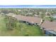 Townhomes with private patios, surrounded by lush green grass and palm trees at 1211 Capri Isles Blvd # 58, Venice, FL 34292