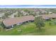 Aerial view of the community highlights the rows of homes, green lawns, and mature trees at 1211 Capri Isles Blvd # 58, Venice, FL 34292