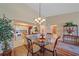 Dining area with view of the kitchen, glass-top table, and decorative rug at 1211 Capri Isles Blvd # 58, Venice, FL 34292