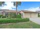 Attractive front yard with well-maintained landscaping and attached garage at 1211 Capri Isles Blvd # 58, Venice, FL 34292
