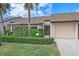 Inviting front yard with lush landscaping and attached garage at 1211 Capri Isles Blvd # 58, Venice, FL 34292