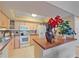 Bright kitchen with white appliances, ample counter space, and decorative backsplash at 1211 Capri Isles Blvd # 58, Venice, FL 34292