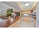 Open kitchen with breakfast bar and pass-through window overlooking the dining area at 1211 Capri Isles Blvd # 58, Venice, FL 34292