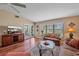 Bright living room with view of the yard through the large windows at 1211 Capri Isles Blvd # 58, Venice, FL 34292