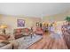 Open living room and dining area with vaulted ceilings and comfortable furniture at 1211 Capri Isles Blvd # 58, Venice, FL 34292