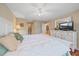 Main bedroom with white bed and dresser, lots of light and ensuite bathroom at 1211 Capri Isles Blvd # 58, Venice, FL 34292