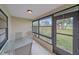 Screened-in patio offers serene views of a green landscape and trees at 1211 Capri Isles Blvd # 58, Venice, FL 34292