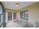 Screened patio with tiled floor and glass patio table and chairs at 1211 Capri Isles Blvd # 58, Venice, FL 34292