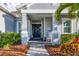 Inviting front porch with rocking chair and lush landscaping at 12456 Destin Loop, Venice, FL 34293