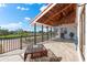 Covered balcony with outdoor grill, seating, and views of the water and surrounding homes at 130 Green Dolphin Dr, Placida, FL 33946