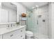 Modern bathroom with white vanity, glass shower, and decorative tile flooring at 130 Green Dolphin Dr, Placida, FL 33946