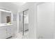 Bright, white bathroom with dual vanity, mirrors, and sliding closet doors at 130 Green Dolphin Dr, Placida, FL 33946