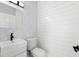 Small bathroom with white vanity, toilet, and decorative wallpaper at 130 Green Dolphin Dr, Placida, FL 33946