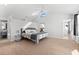 Large bedroom with vaulted ceilings, carpeted floors, and an ensuite bathroom at 130 Green Dolphin Dr, Placida, FL 33946