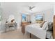 Bright bedroom with ceiling fan, vanity, and large windows at 130 Green Dolphin Dr, Placida, FL 33946