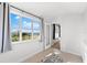 Bedroom with large windows offering scenic views and access to a balcony at 130 Green Dolphin Dr, Placida, FL 33946
