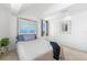 Bright bedroom featuring vaulted ceilings, carpeted flooring, and stylish wall art at 130 Green Dolphin Dr, Placida, FL 33946