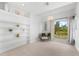 Charming bedroom with white built-in shelves, large window, and comfortable seating area at 130 Green Dolphin Dr, Placida, FL 33946