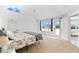 Spacious main bedroom with vaulted ceilings, large windows, and access to a balcony at 130 Green Dolphin Dr, Placida, FL 33946