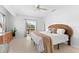Spacious bedroom with ceiling fan, double doors leading to a balcony, and ample natural light at 130 Green Dolphin Dr, Placida, FL 33946
