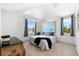 Cozy bedroom with vaulted ceilings, carpeted floors, and large windows offering natural light at 130 Green Dolphin Dr, Placida, FL 33946