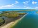 Tranquil coastal inlet with lush greenery, calm waters, and distant ocean views at 130 Green Dolphin Dr, Placida, FL 33946