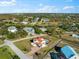 Aerial perspective highlighting the surrounding homes, streets, canals, and lots at 130 Green Dolphin Dr, Placida, FL 33946