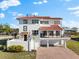 Beautiful two-story home with a red tile roof, balcony, and attached garage at 130 Green Dolphin Dr, Placida, FL 33946