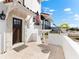 Welcoming front entry with a covered porch, brown door, and American flag at 130 Green Dolphin Dr, Placida, FL 33946
